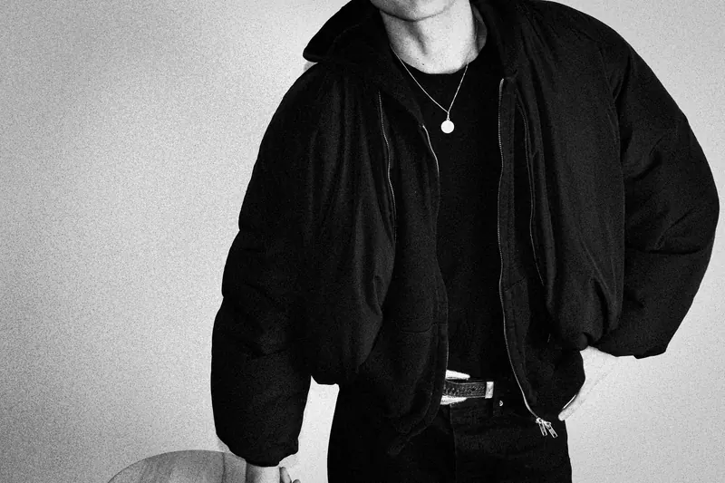 Pedro’s dark jacket, necklace, and belt, with the face cropped out of the frame