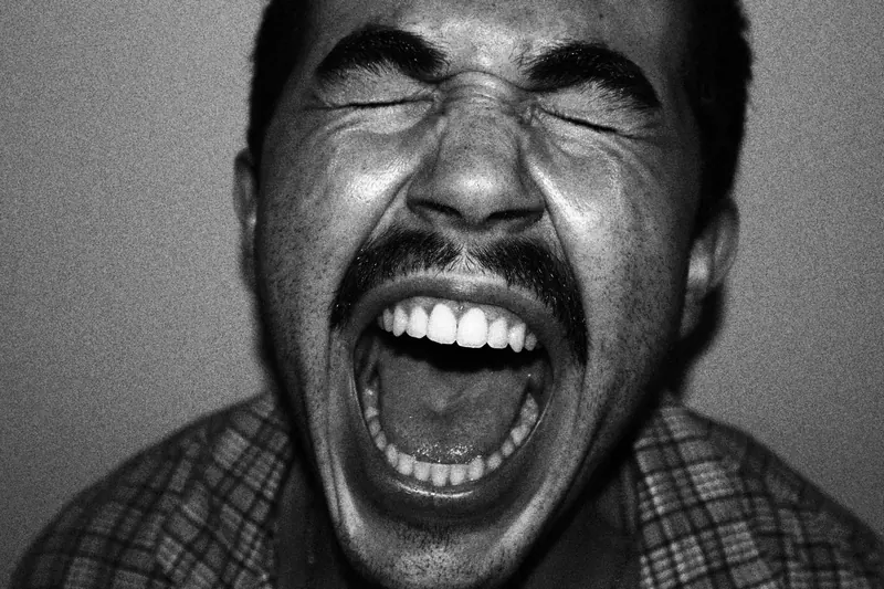 Close portrait of Tristan with eyes closed and mouth wide open