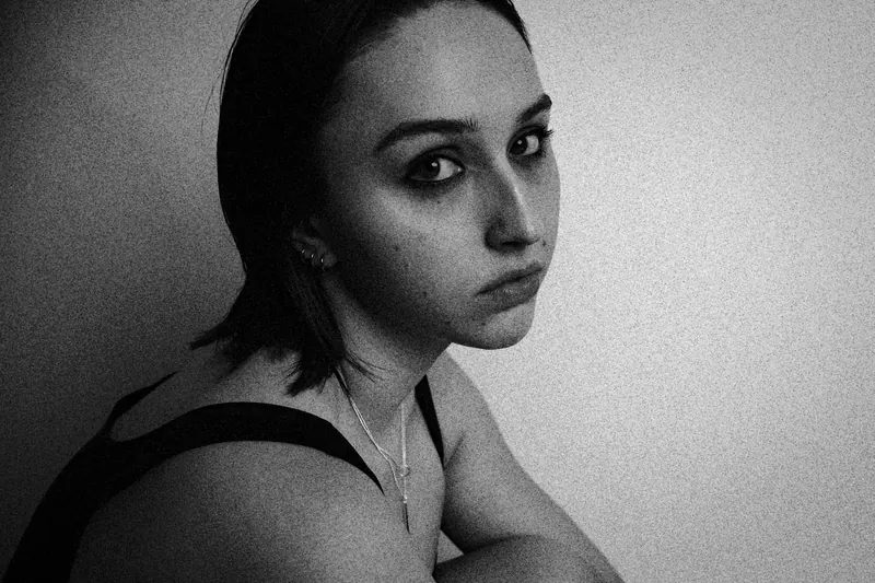 Alyssa seated with one shoulder turned toward the camera