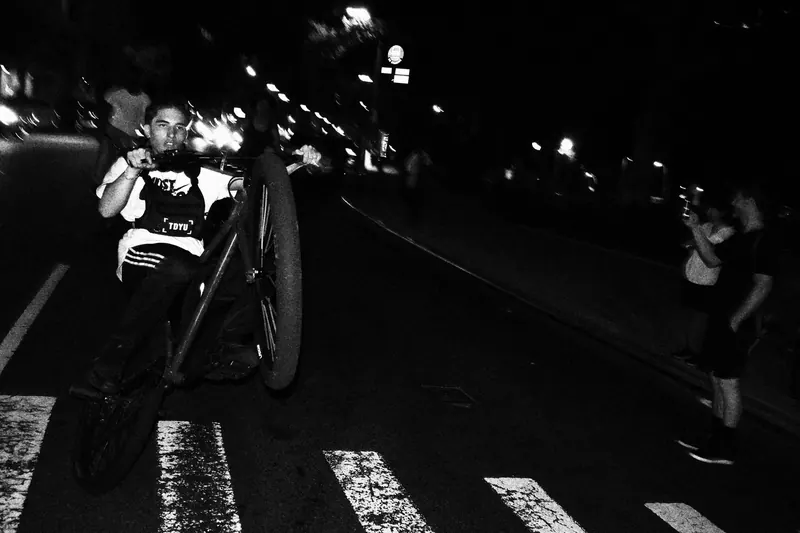 Man doing wheelie on bike