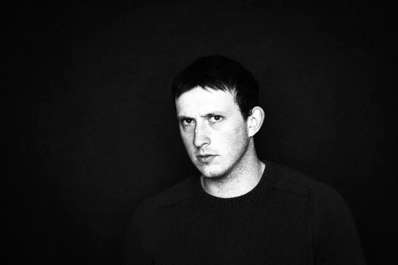 James turning slightly toward the camera against a dark background