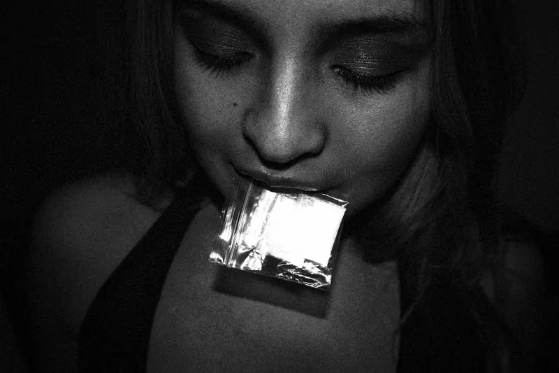 a woman with a small bag in her mouth