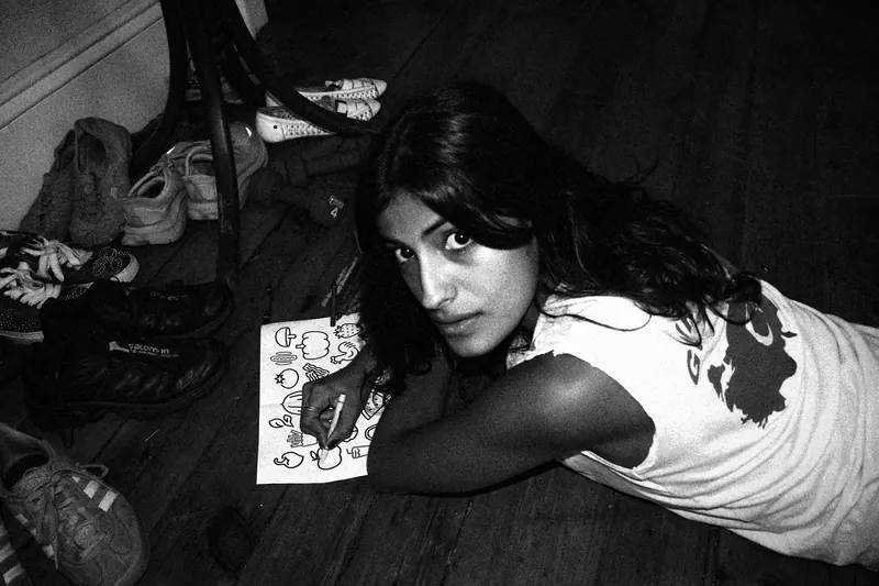 Vanessa lying on the floor and turning to look up at the camera