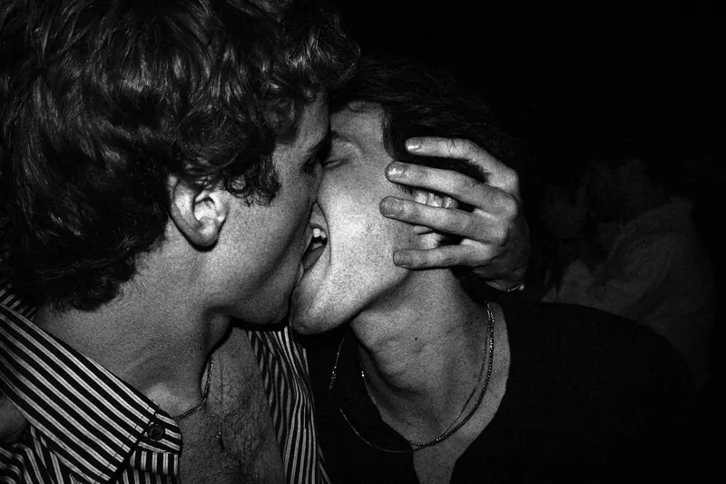 Two men kissing