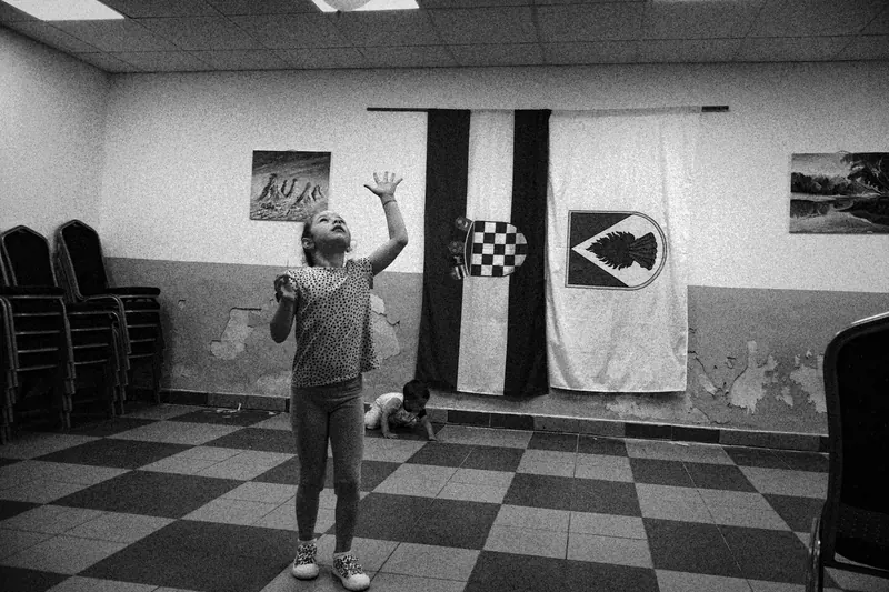 two children playing infornt of the croatian flag