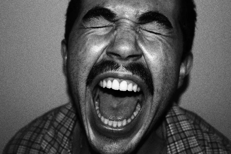 Close portrait of Tristan with eyes closed and mouth wide open