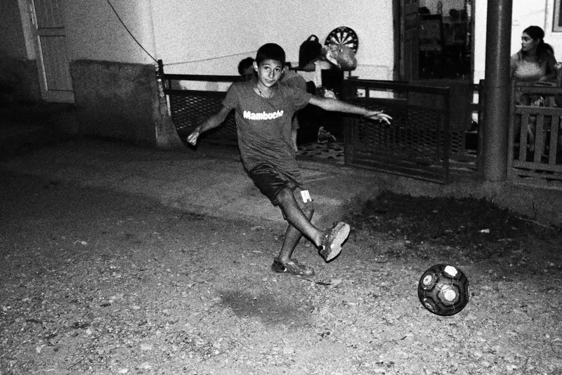boy kicking soccer ball