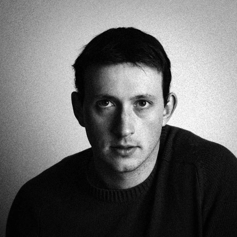 Close portrait of James looking into the camera with one side of the face in shadow