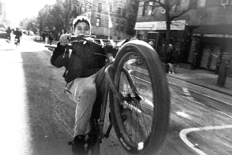 Man doing wheelie on bike